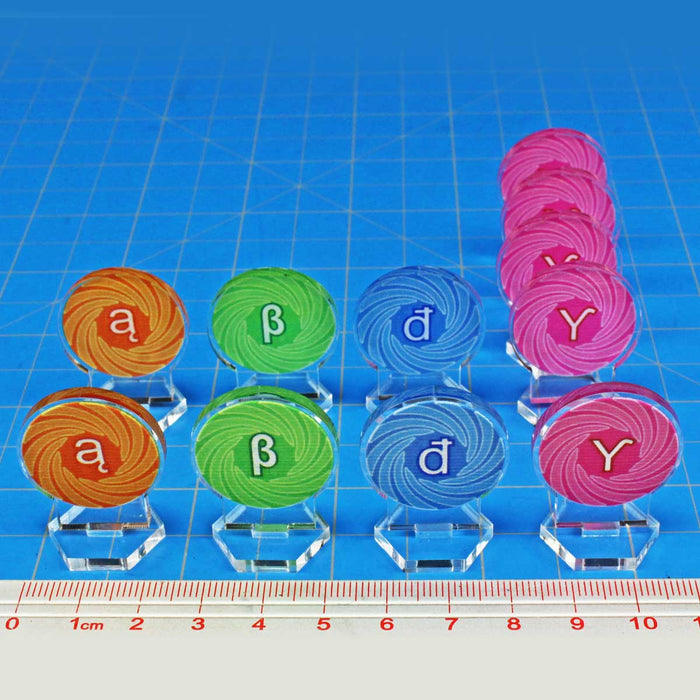 Full set of color-coded wormhole markers for Twilight Imperium and Thunder's Edge on a metric ruler, featuring Alpha, Beta, Delta, and Gamma tokens.